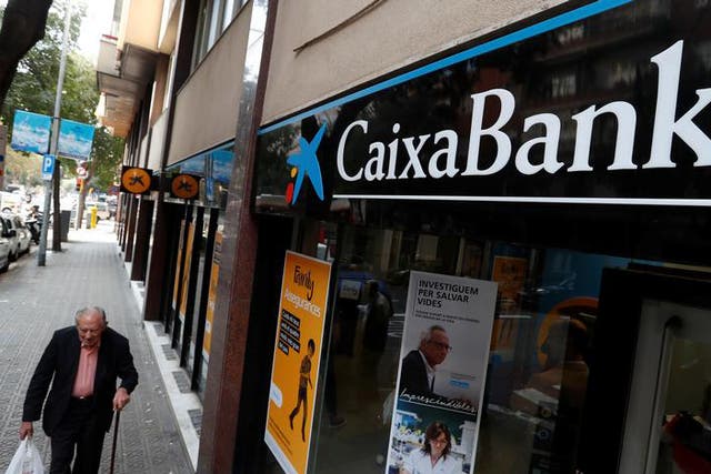 A man walks past a Caixa bank branch in Barcelona, Spain October 6, 2017. REUTERS/Yves Herman