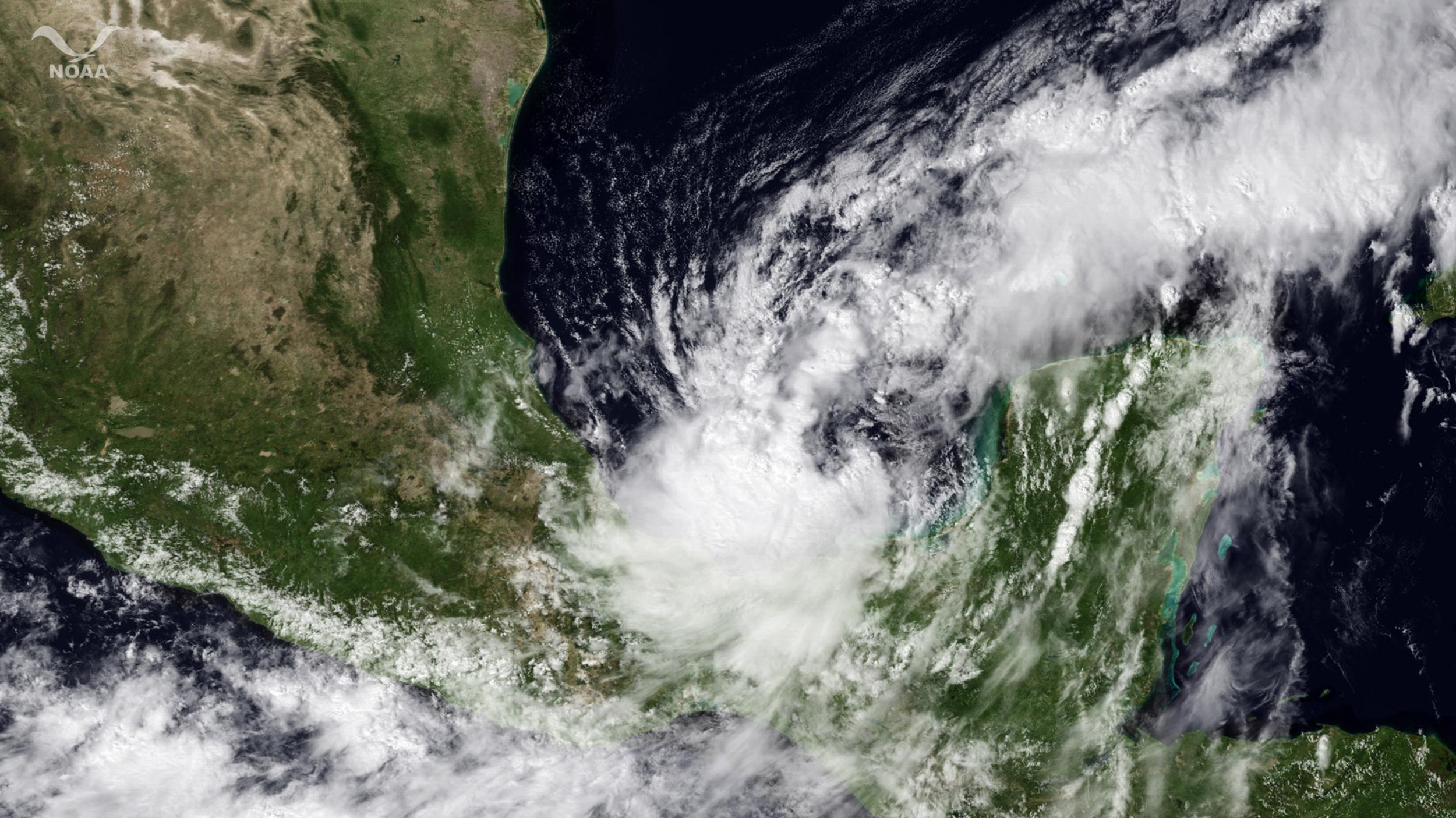 In this satellite handout from National Oceanic and Atmospheric Administration, Tropical Storm Nate passes near the Yucatan Peninsula