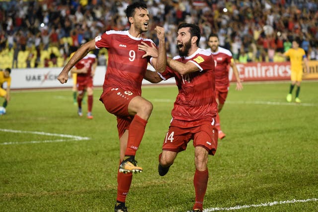 Omar Al Somah of Syria (left) celebrates his late equaliser from the penalty spot during Thursday’s World Cup qualifying match between Syria and Australia at the Hang Jebat Stadium in Malacca on 5 October 2017