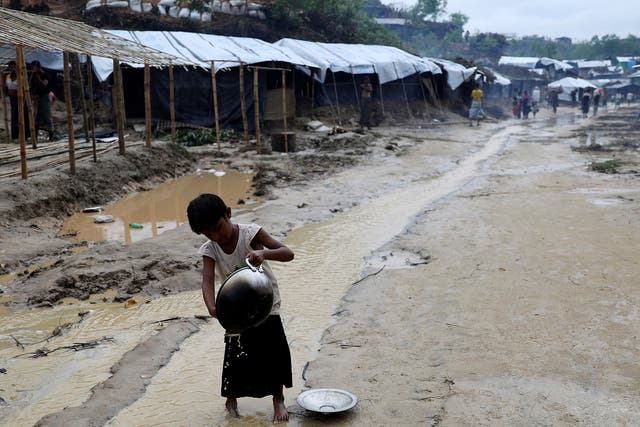 A Rohingya refugee child washes utensil in the in the Balukhali refugee camp in Cox's Bazar, Bangladesh