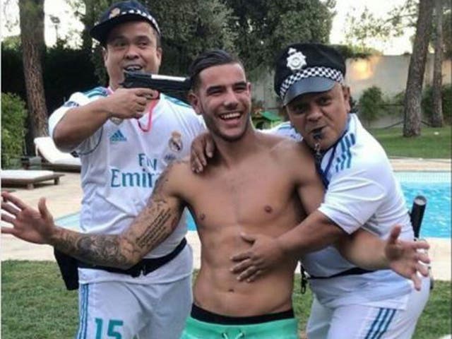 Theo Hernandez poses with dwarf policemen - one of whom has a gun