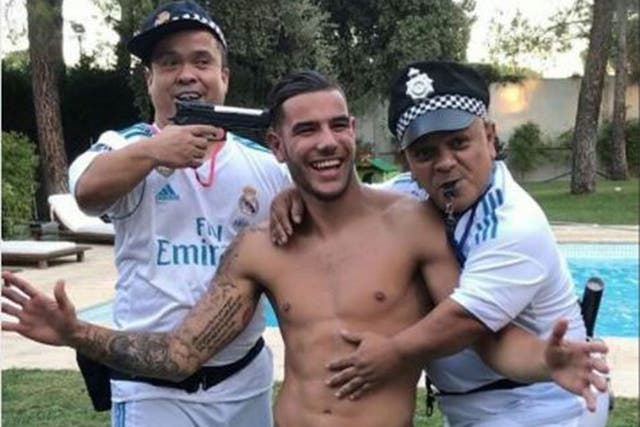 Theo Hernandez poses with dwarf policemen - one of whom has a gun