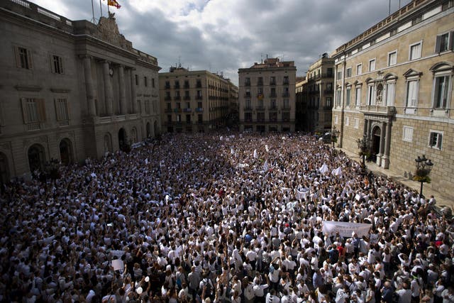 Thousands gathered in Barcelona wearing white and carrying doves as a symbol of their desire for a peaceful solution to the Catalonia crisis