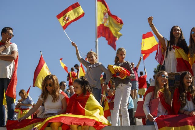 Pro-unity demonstrators hold Spanish flags during the rally called by the DANAES foundation at Colon Square in Madrid