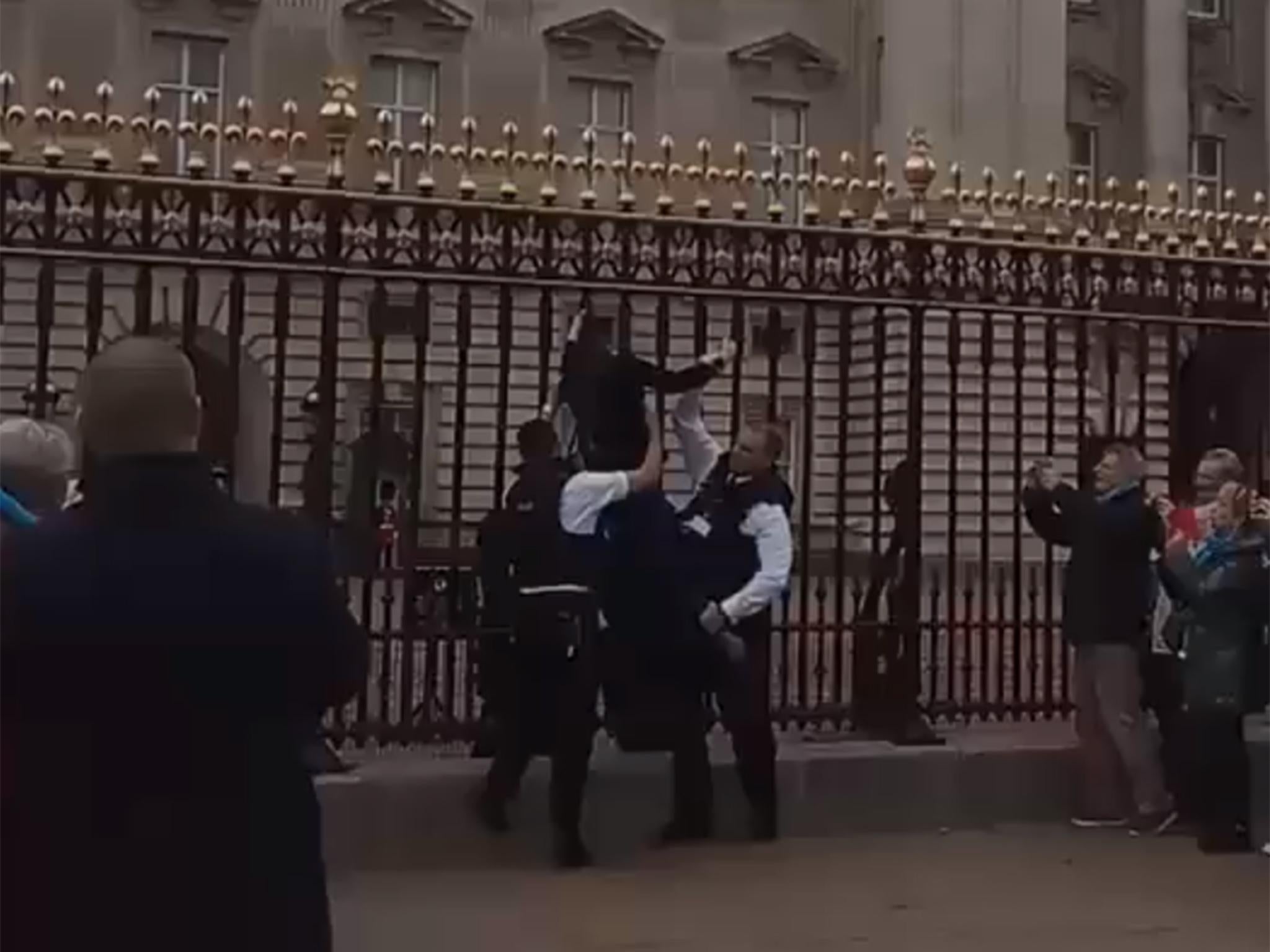 The woman was hauled off the gates