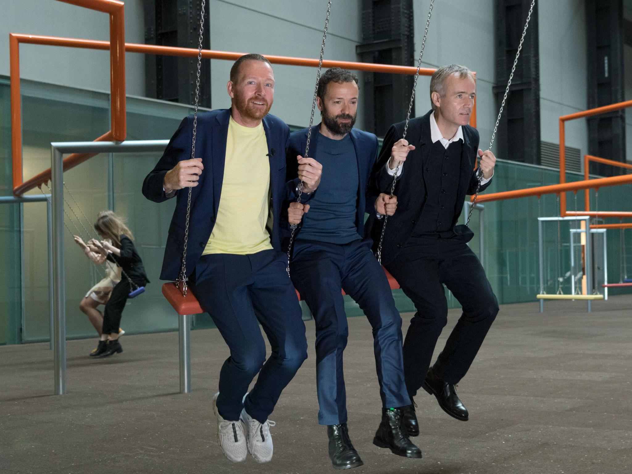 The Danish trio Superflux – from left, Jakob Fenger, Bjornstjerne Christiansen and Rasmus Nielsen – on swings at Tate's Turbine Hall, which has been turned into a kids' playground called 'One Two Three Swing!'