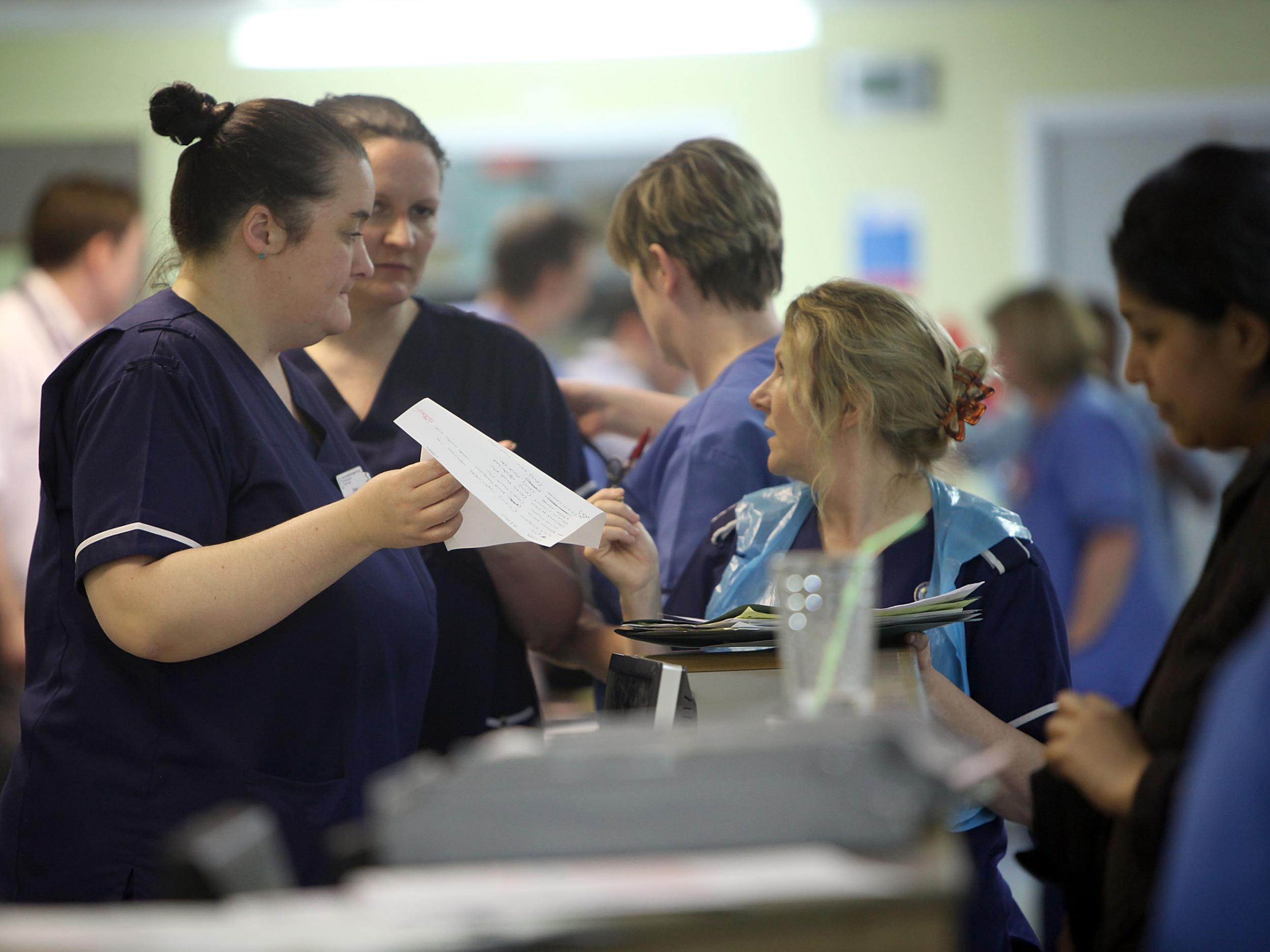 Nurses work during a busy shift in an A&E department