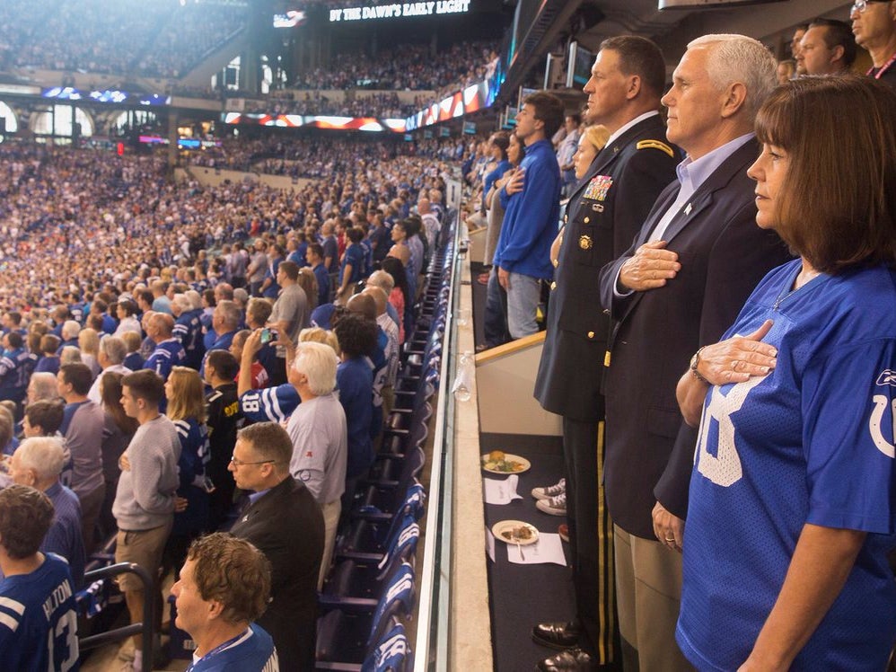 Vice President Mike Pence stands for the national anthem at a game