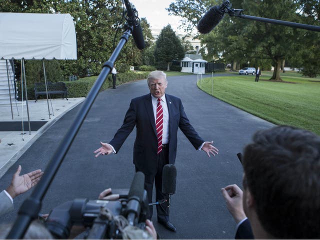 Donald Trump speaks with reporters outside the White House prior to his departure aboard Marine One on 7 October