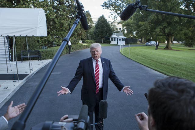  Donald Trump speaks to reporters outside the White House