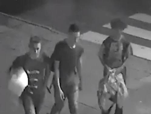 The boys walking through the town with the duvet