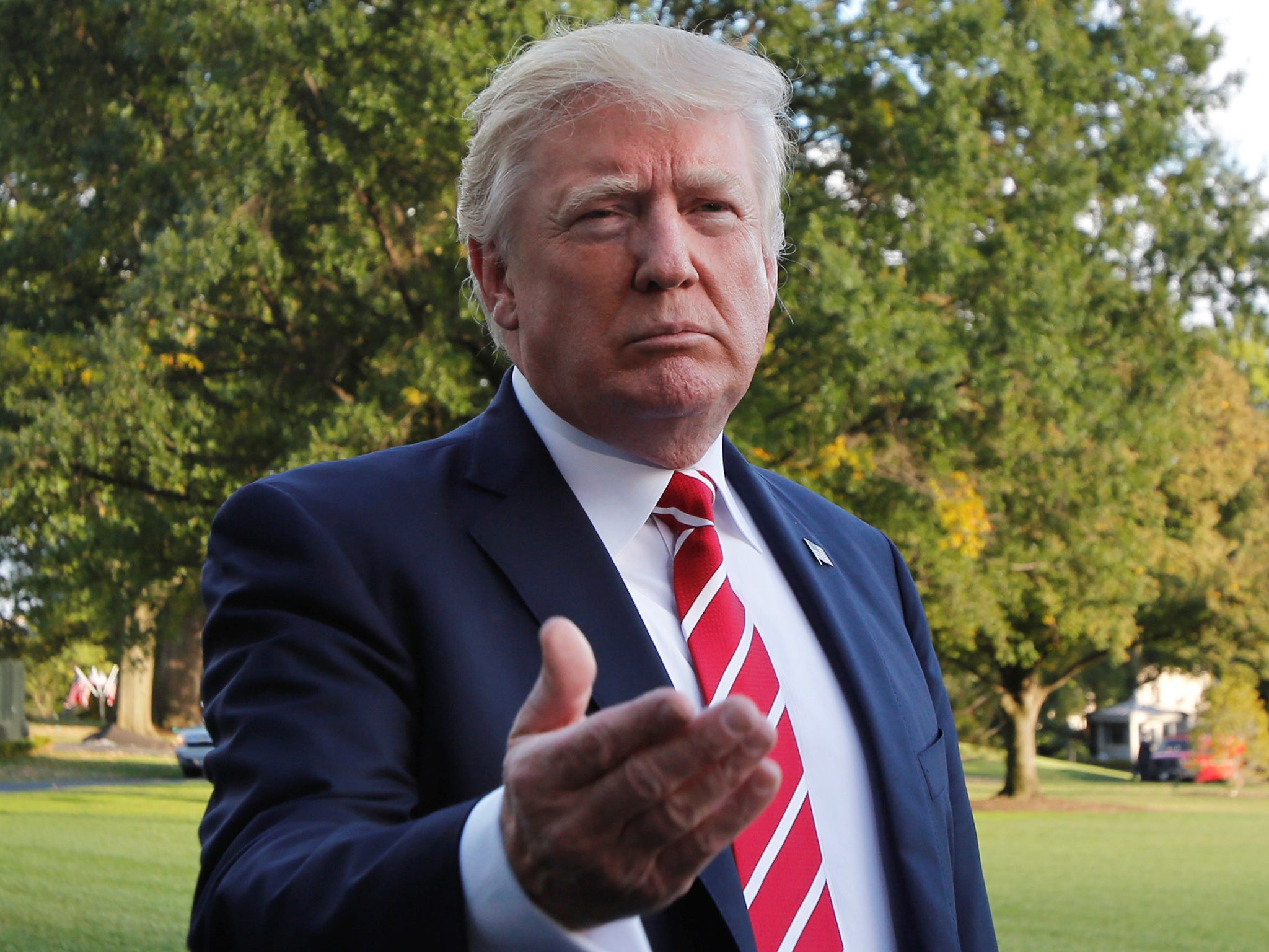 President Donald Trump talks to the media on South Lawn of the White House