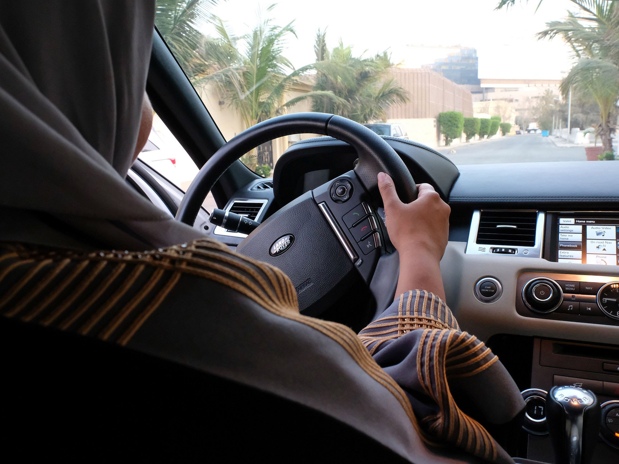 A Saudi woman drives her car down the street in Jeddah. The country is the only one in the world which bans female drivers