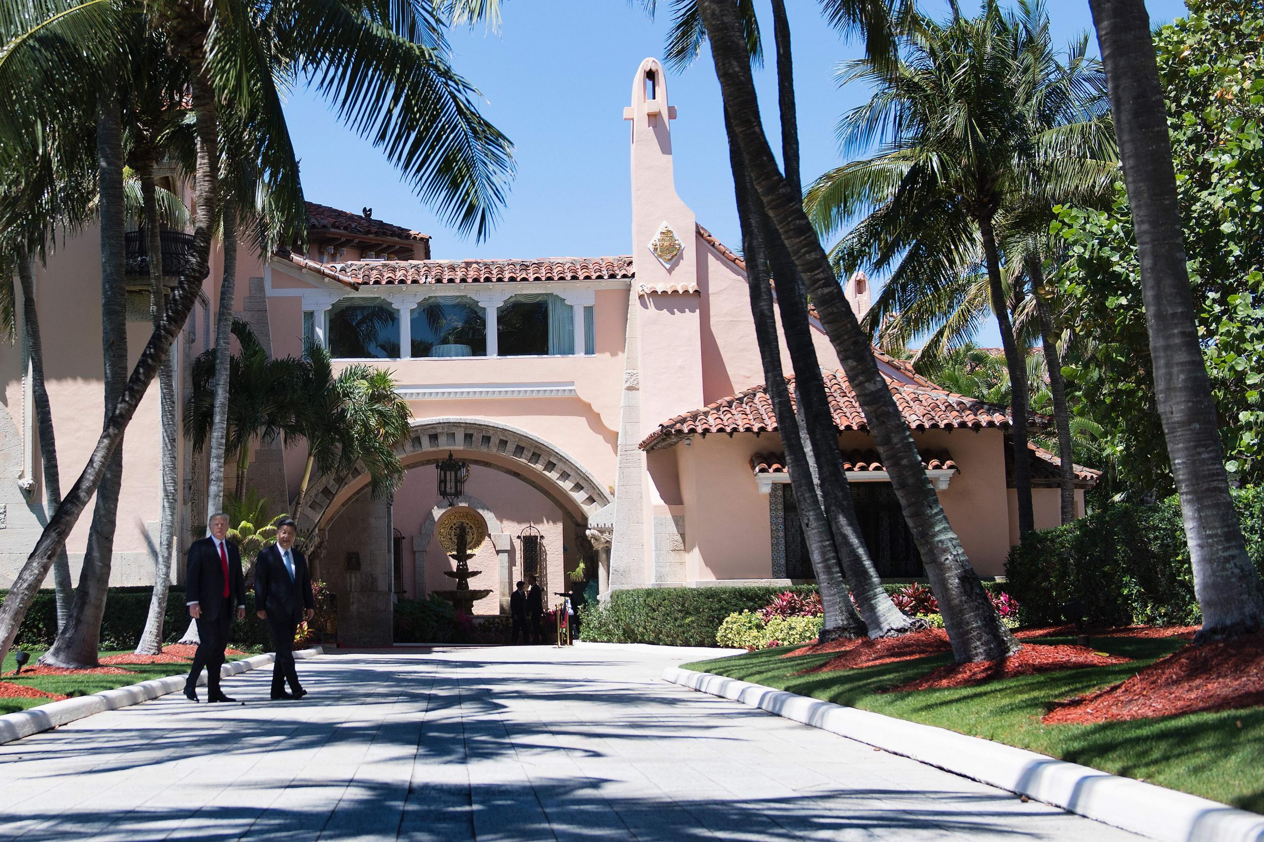 Donald Trump and Chinese President Xi Jinping walk together at the Mar-a-Lago estate in West Palm Beach, Florida