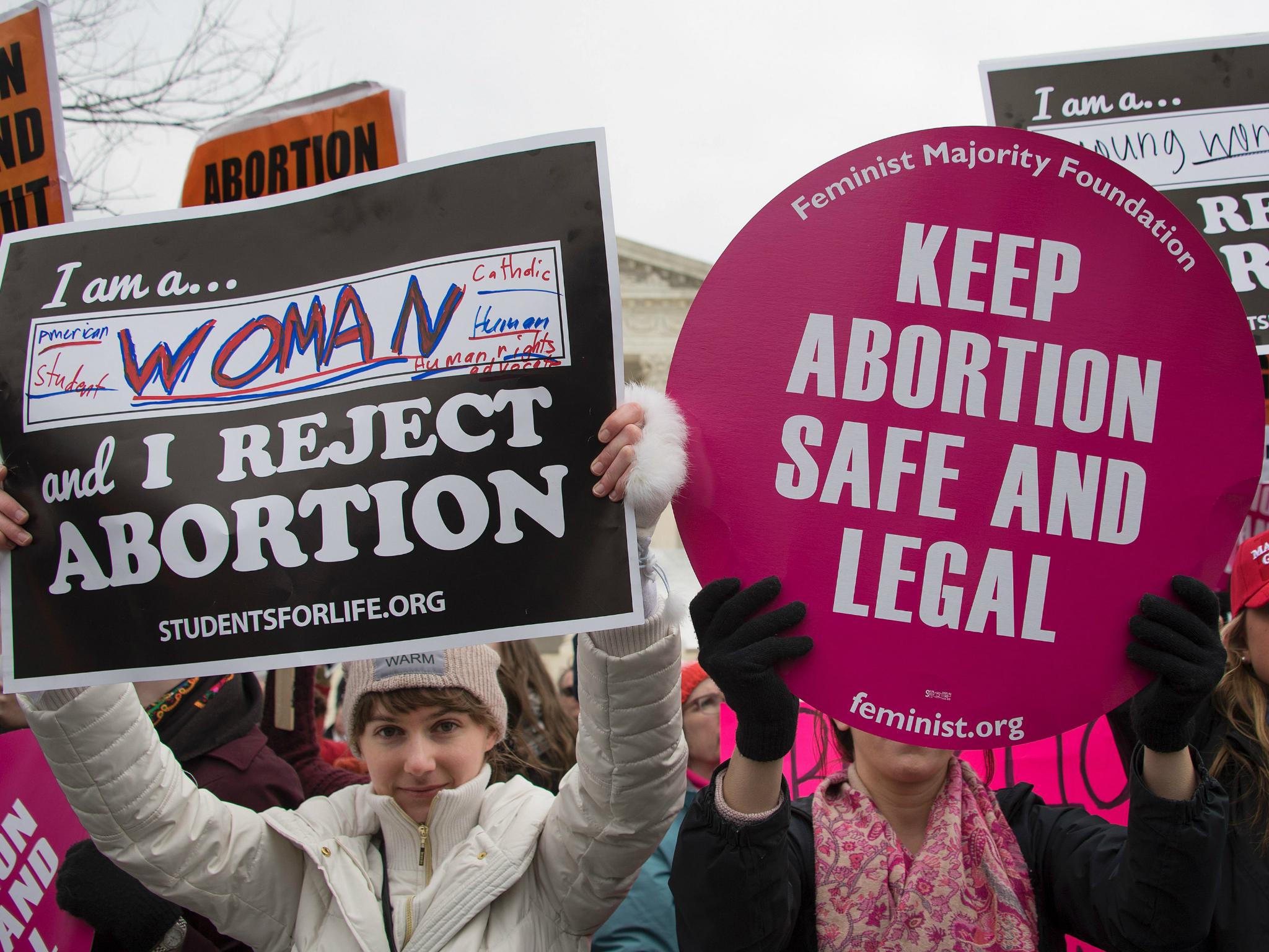 A pro-choice activist demonstrates in the middle of pro-life activists as they demonstrate in front of the US Supreme Court during the March For Life in Washington DC 27 January 2017.