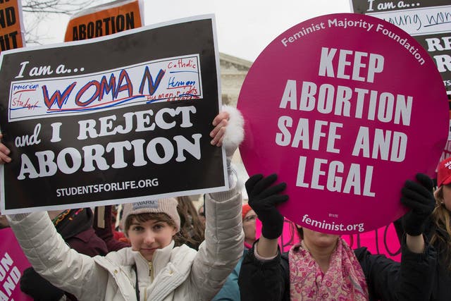 A pro-choice activist demonstrates in the middle of pro-life activists as they demonstrate in front of the US Supreme Court during the March For Life in Washington DC 27 January 2017.