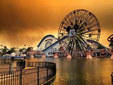 Apocalyptic sky above Disneyland California as fires coat rides in ash