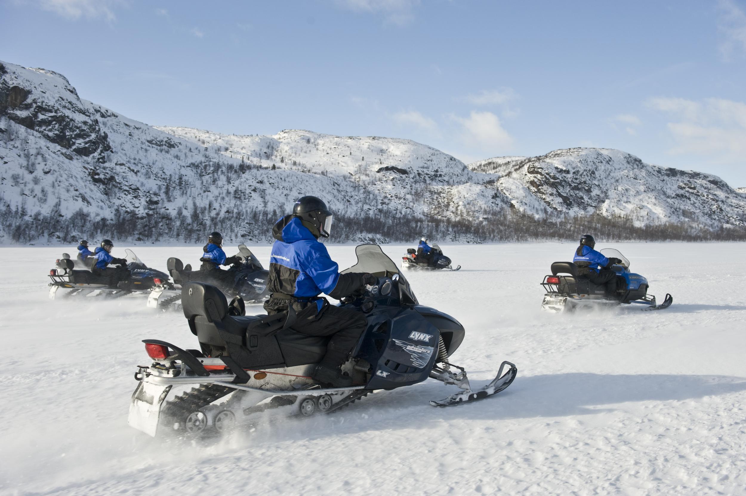 Explore the Arctic terrain on a snowmobile