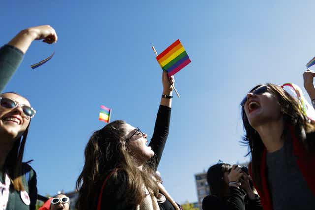 Campaigners for LGBT rights wave the rainbow flag