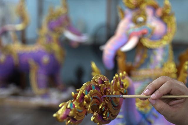 An artist works on a deity sculpture which will decorate the funeral pyre of the late King Bhumibol Adulyadej, near the Grand Palace in Bangkok