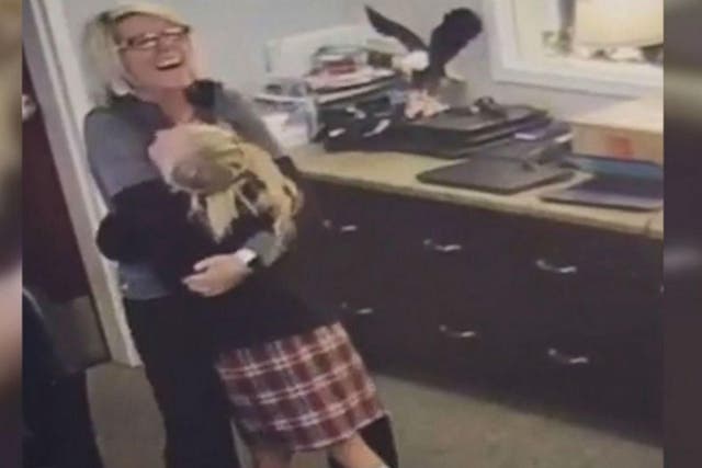 A camera caught the moment when the girl hugged the school worker