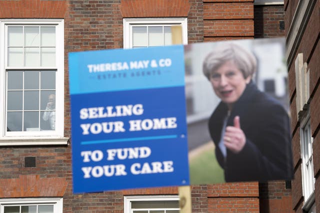 Liberal Democrat campaigners carry placards as they demonstrate against Theresa May's 'Dementia Tax' before the general election