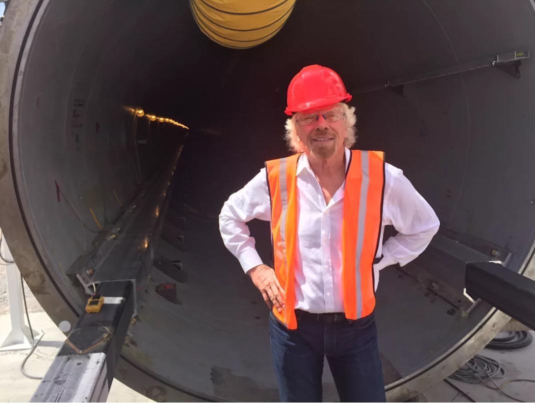 Richard Branson stands in front of some of the machinery required for the Hyperloop