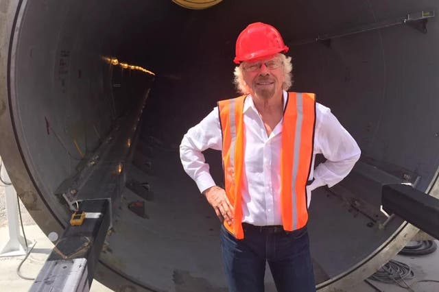 Richard Branson stands in front of some of the machinery required for the Hyperloop
