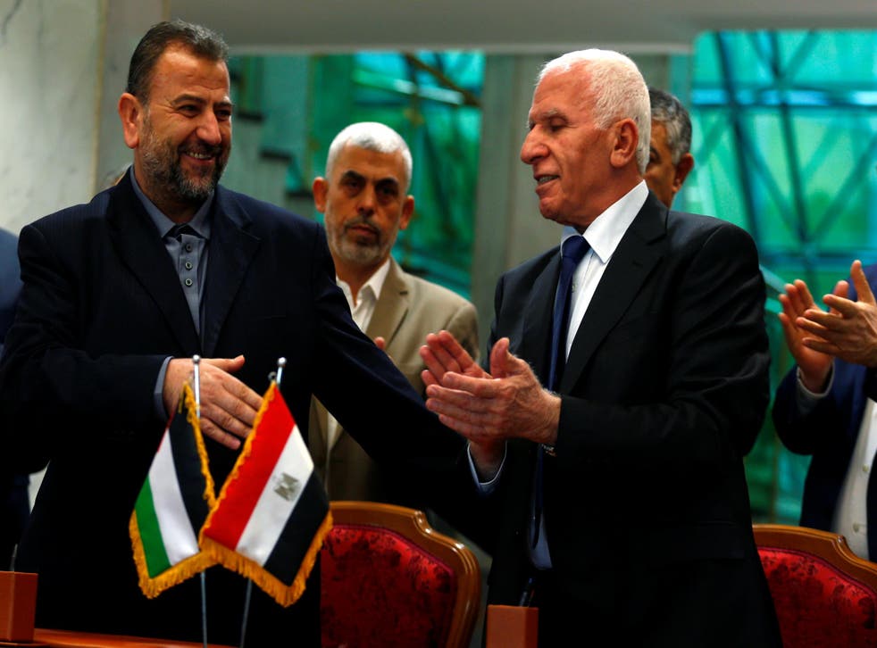 Head of Hamas delegation Saleh Arouri, and Fatah negotiator Azzam Ahmad, sign a reconciliation deal in Cairo, Egypt, on 12 October 2017