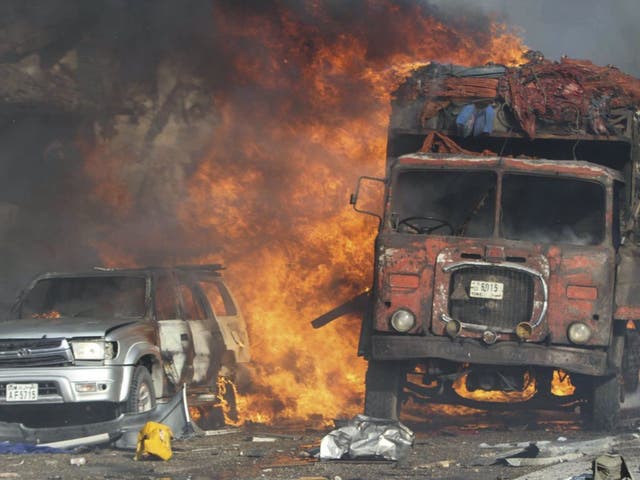 Vehicles burn at the scene of a massive explosion in front of Safari Hotel in the capital Mogadishu, Somalia