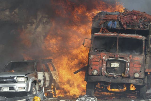 Vehicles burn at the scene of a massive explosion in front of Safari Hotel in the capital Mogadishu, Somalia