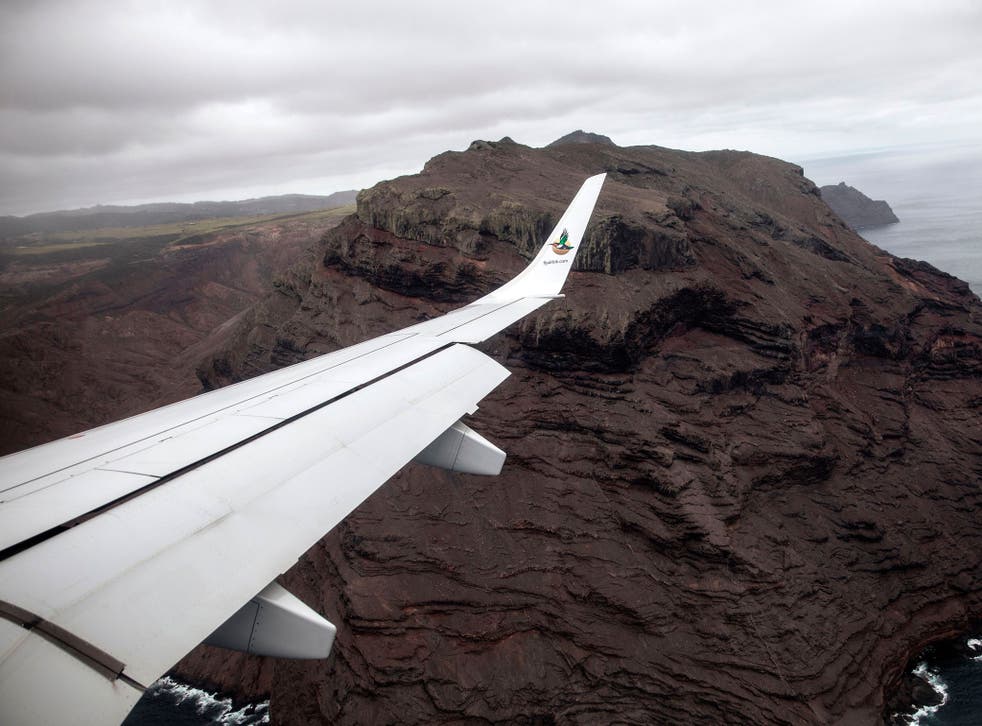 The inaugural commercial flight between Johannesburg and Saint Helena shows the cliffs of the volcanic tropical island