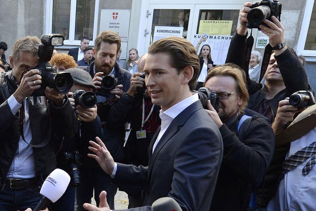 Austria's Foreign Minister and leader of Austria's centre-right People's Party (OeVP) Sebastian Kurz talks with journalists in front of a polling station during general elections in Vienna