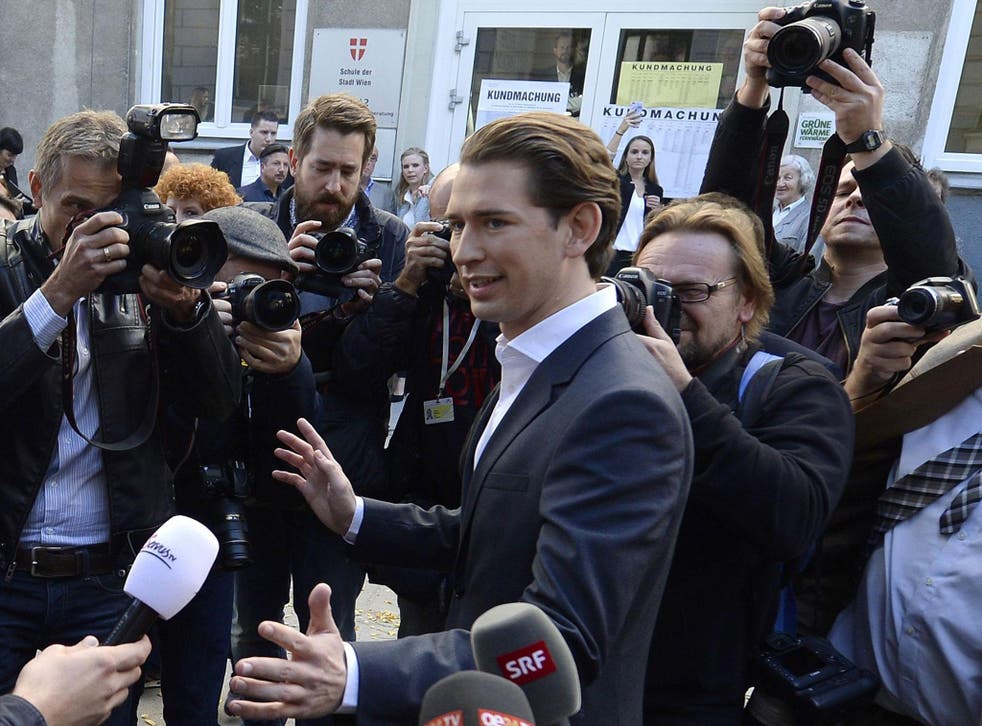 Austria's Foreign Minister and leader of Austria's centre-right People's Party (OeVP) Sebastian Kurz talks with journalists in front of a polling station during general elections in Vienna