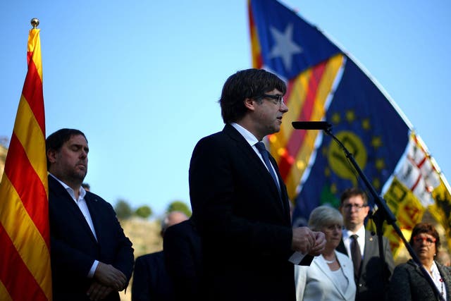 Catalan President Carles Puigdemont delivers a speech at the memorial of ‘Fossar de la Pedrera’ in Barcelona on Sunday