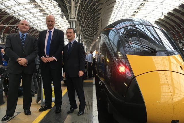 Better late: Transport Secretary Chris Grayling (centre) with the first Intercity Express Train to arrive at London Paddington station