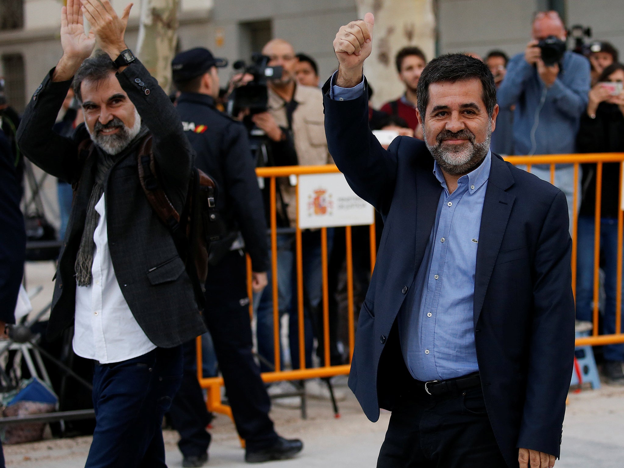 Jordi Cuixart (L), leader of Omnium Cultural, and Jordi Sanchez of the Catalan National Assembly, arrive at the High Court in Madrid on 16 October