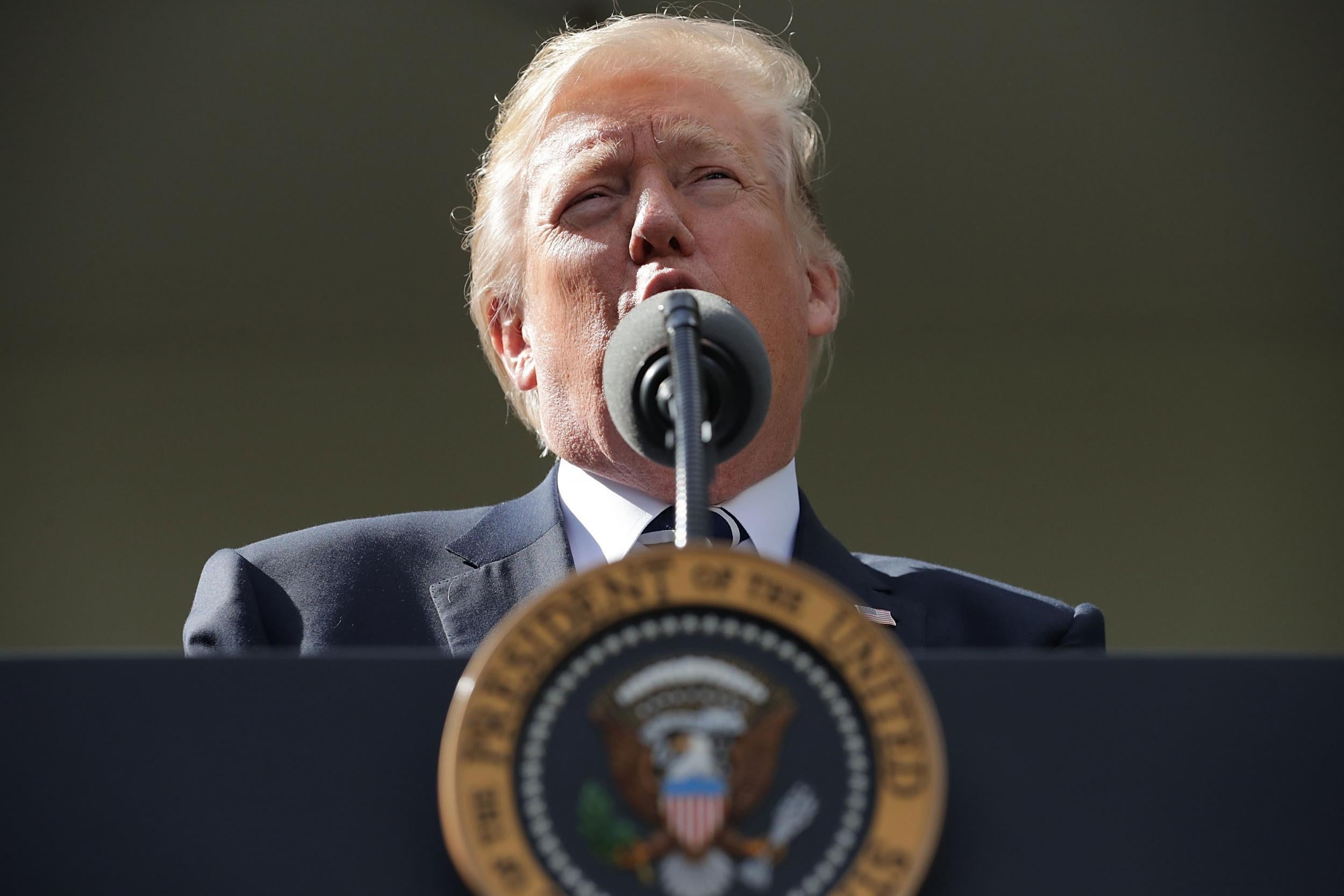 President Donald Trump speaks to reporters in the Rose Garden during a news conference with Senate Majority Leader Mitch McConnell