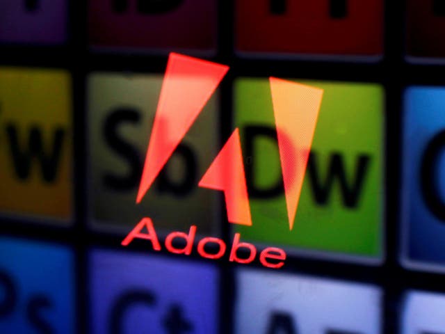 <p>An Adobe logo and Adobe products are seen reflected on a monitor display and an iPad screen, in this picture illustration July 8, 2013</p>