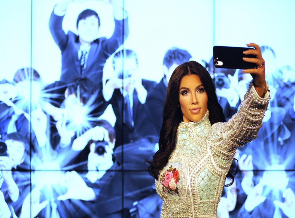 Kim Kardashian's selfies are so iconic that her waxwork features her holding an iPhone