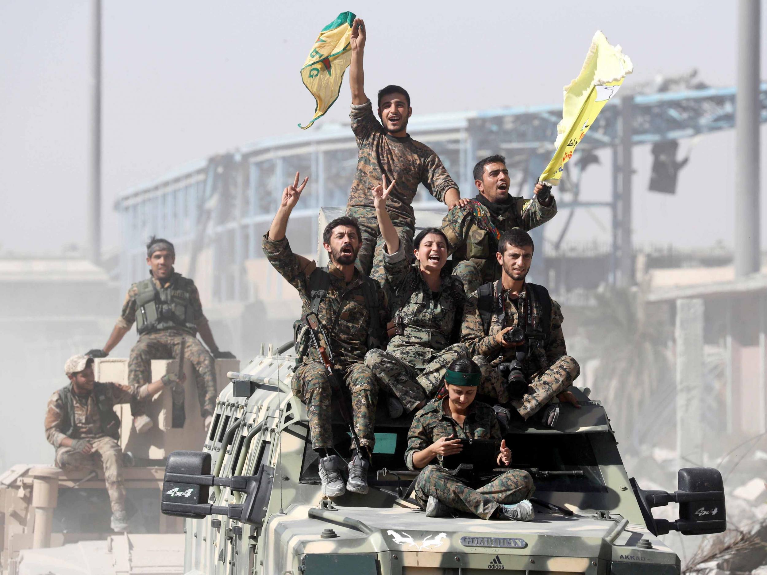 Victorious Kurdish fighters in Raqqa after driving out Isis fighters 