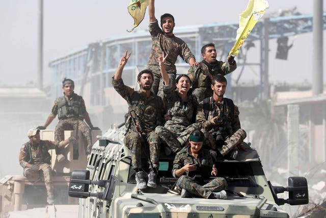 Victorious Kurdish fighters in Raqqa after driving out Isis fighters 