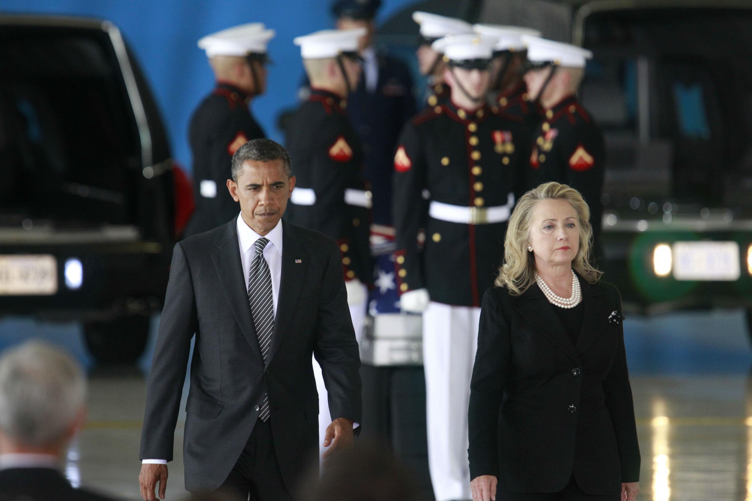 Barack Obama and Hillary Clinton participate in a return ceremony of victims of the Benghazi attack of 2012