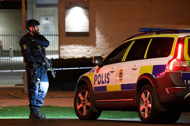 A police officer stands guard outside the area surrounding the police station in Helsingborg