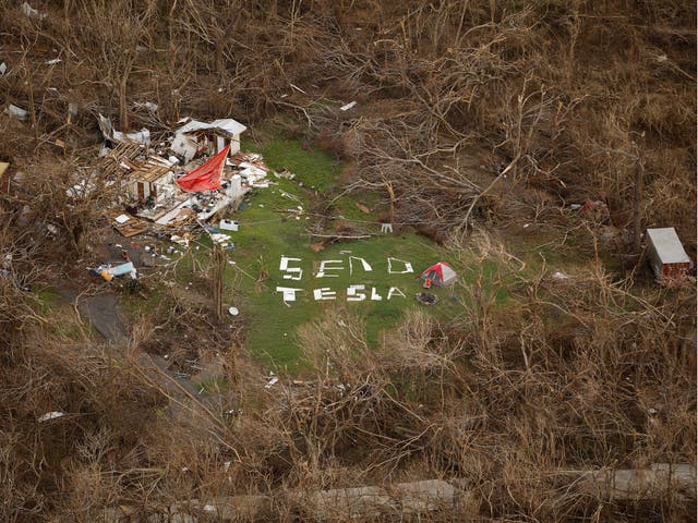 A sign saying "Send Tesla" is spelled out with remnants of a nearby house destroyed by Hurricane Irma on the northern shore of St. John, U.S. Virgin Islands September 16, 2017