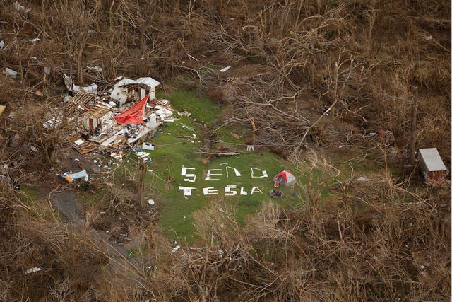 A sign saying "Send Tesla" is spelled out with remnants of a nearby house destroyed by Hurricane Irma on the northern shore of St. John, U.S. Virgin Islands September 16, 2017