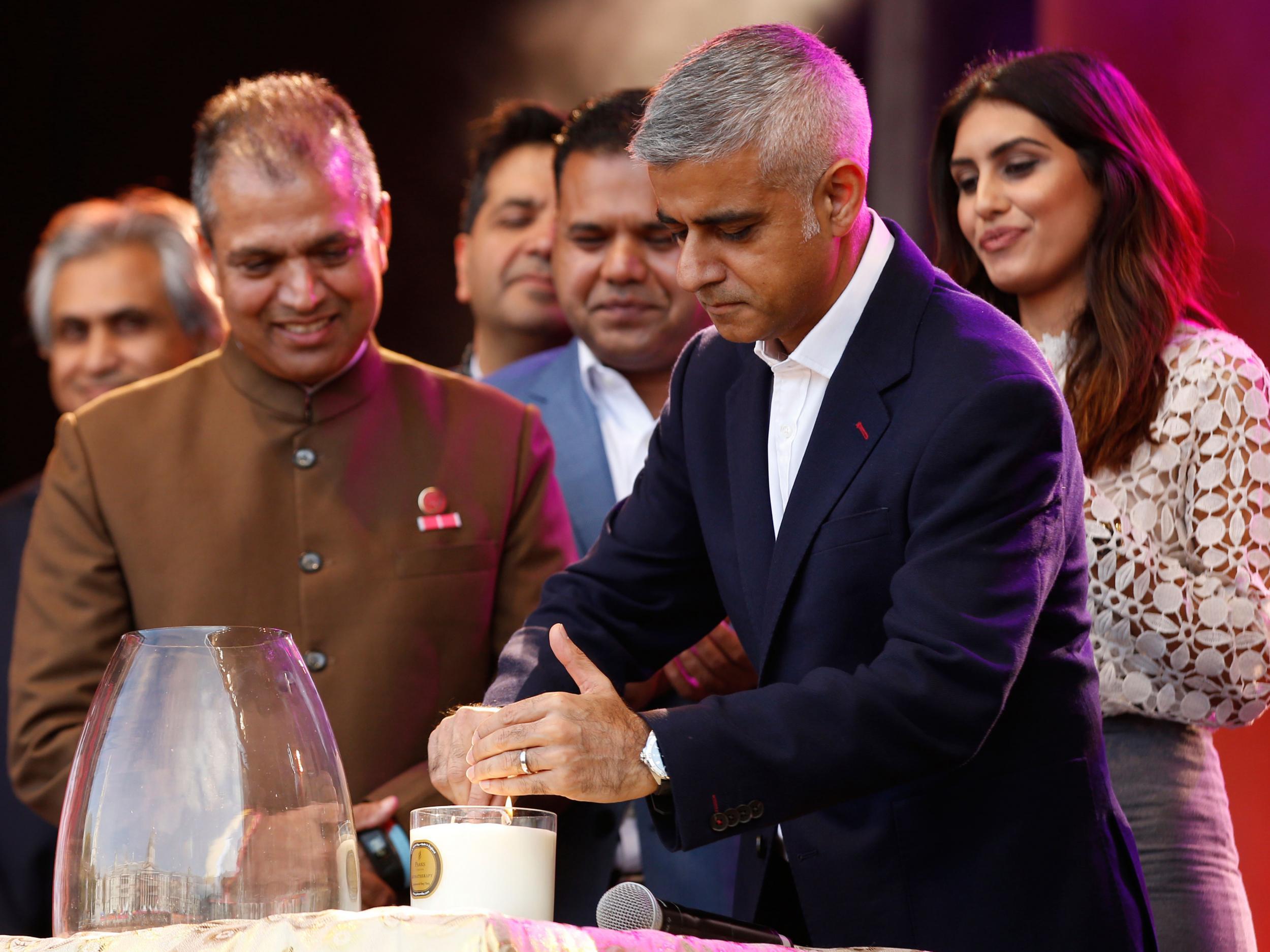 Sadiq Khan lights a candle at a Diwali festival last year
