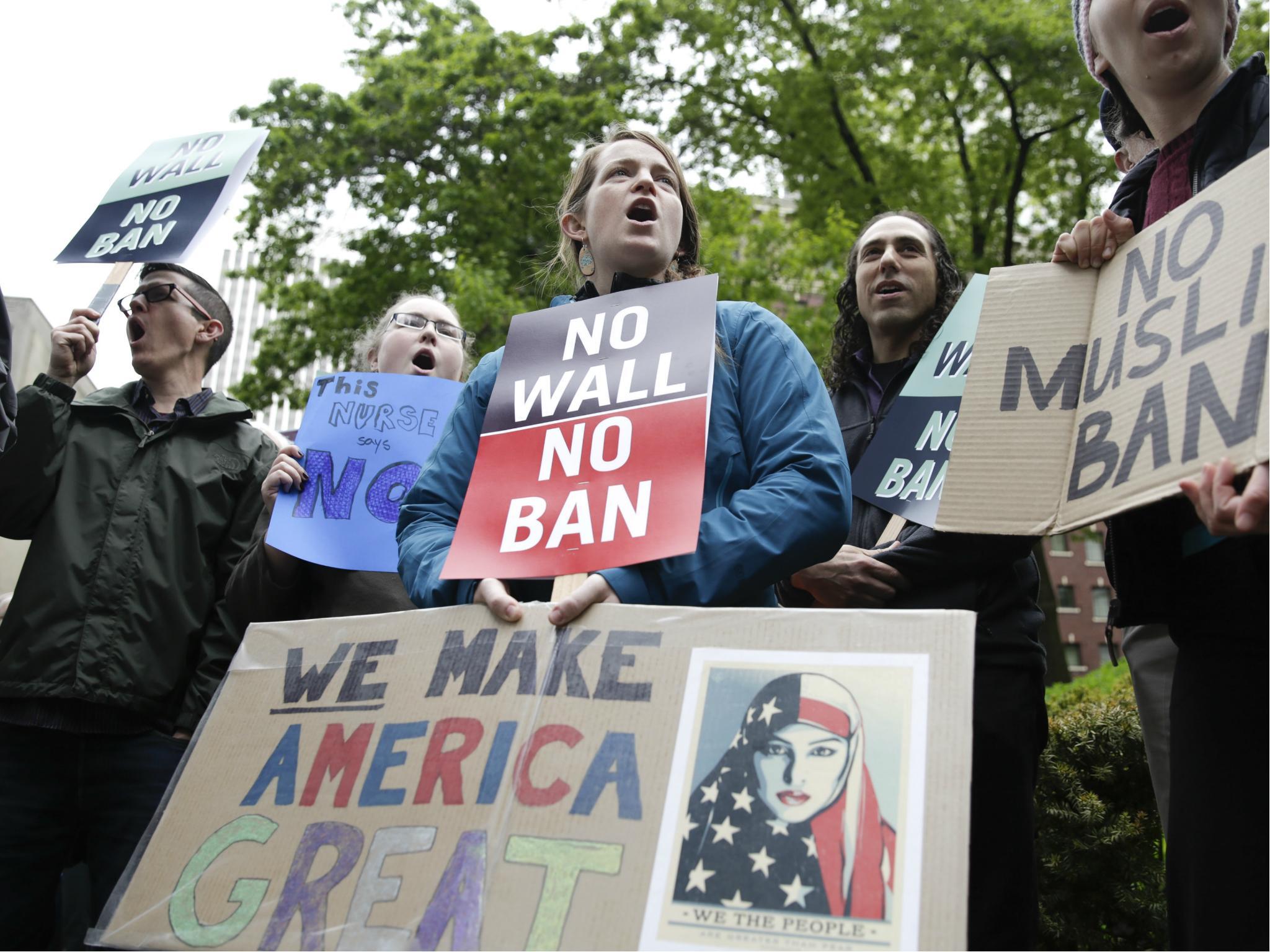 People protest outside as the 9th US Circuit Court of Appeals prepares to hear arguments on US President Donald Trump's revised travel ban in Seattle, Washington on 15 May 2017.