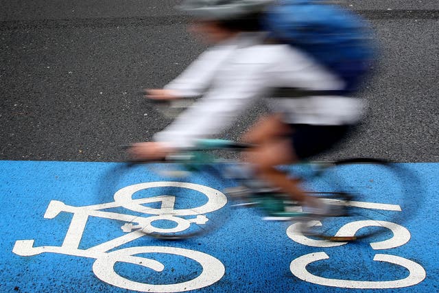 A cyclist rides on a cycle superhighway in Kennington, south London