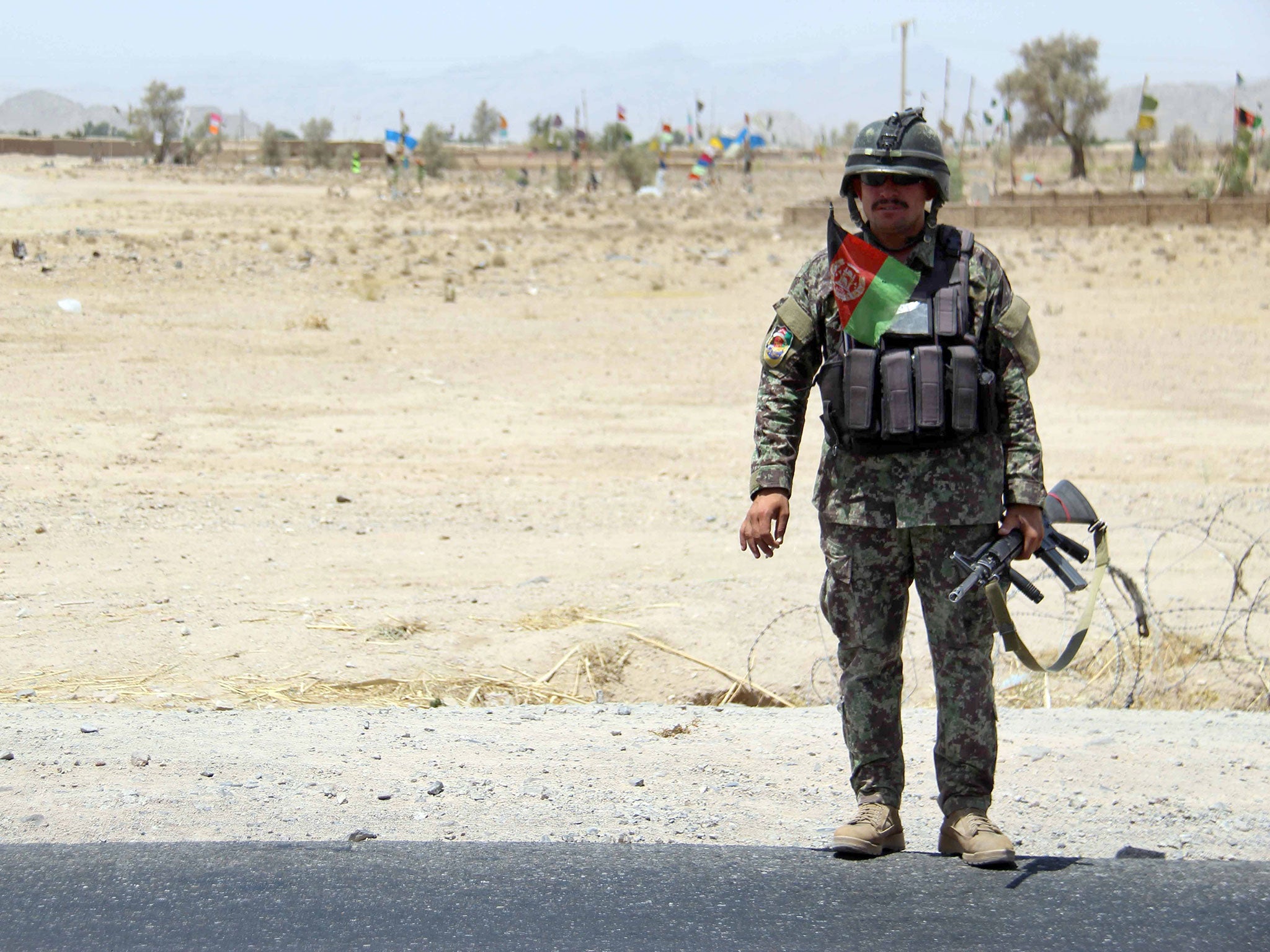 An Afghan Army soldier stands guard at a check point on a highway leading to the Maiwind district of restive Kandahar, Afghanistan, 19 October 2017